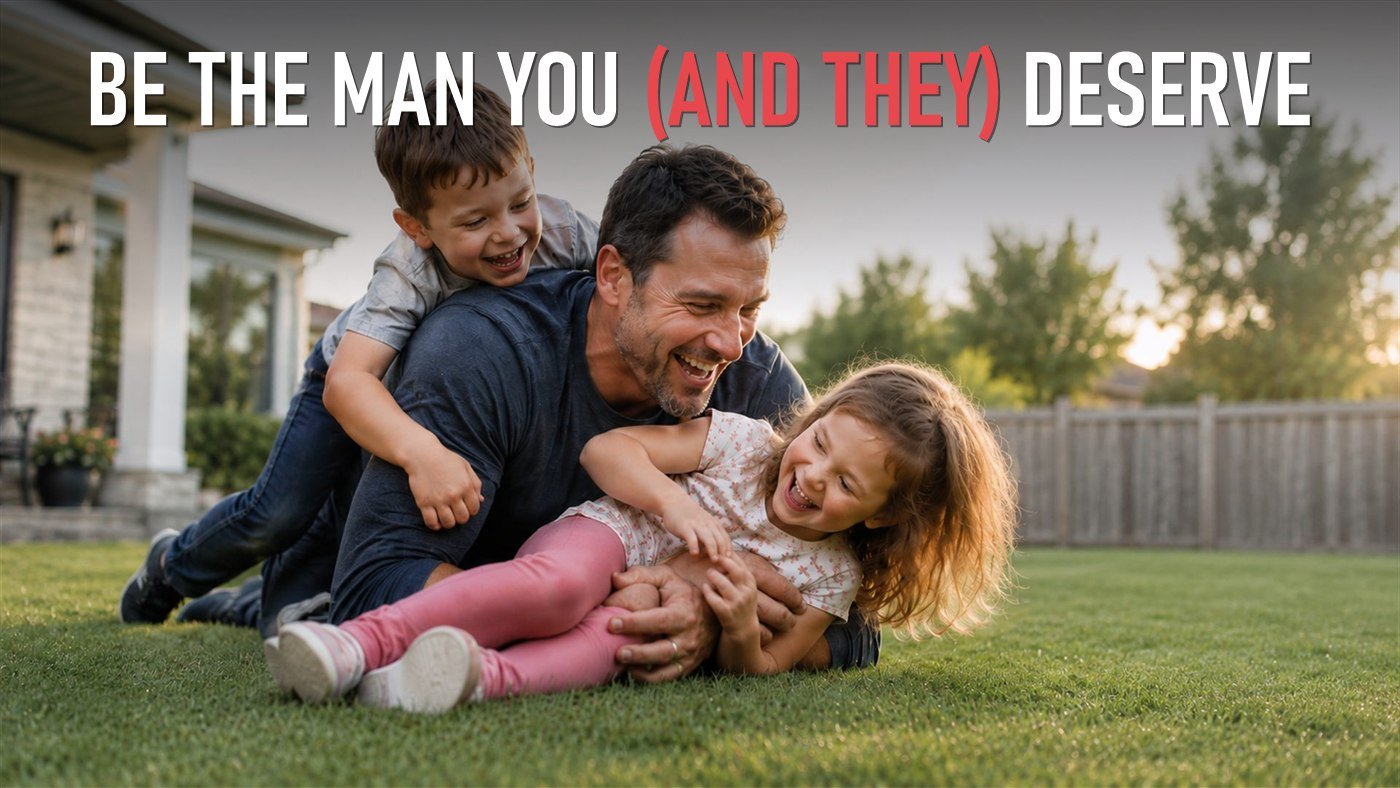 Be the man you (and they) deserve. A man laughing on the grass with his two young children climbing on him.